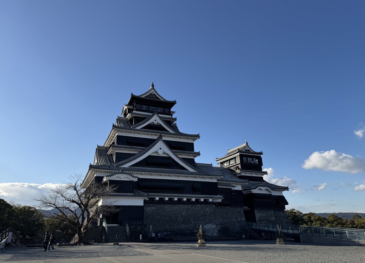 Main tower of Kumamoto Castle, set against a perfect blue sky in mid-afternoon winter