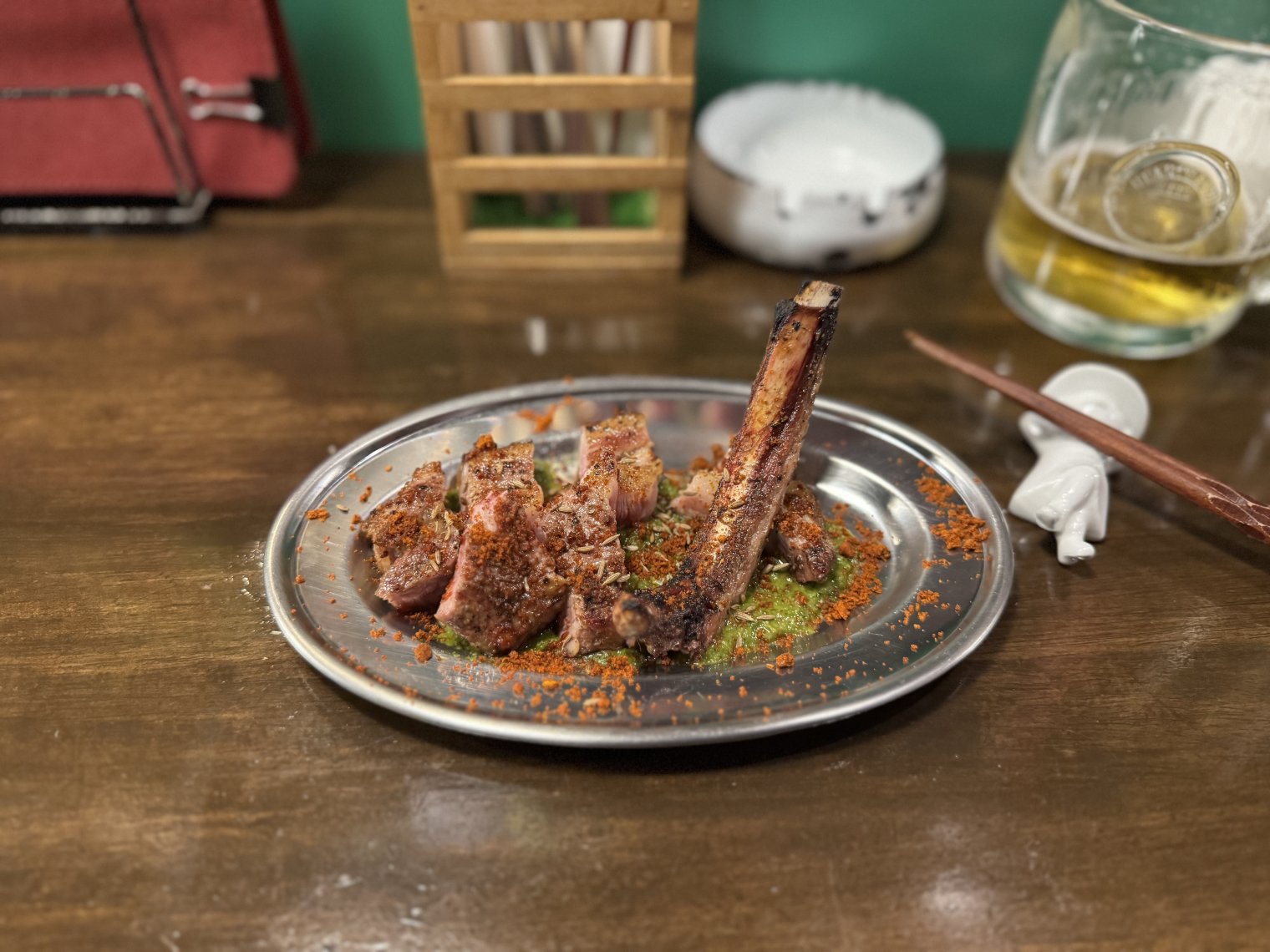 A tiny dish of lamb chops (well, a lamb chop, in tiny pieces) with spices and a bed of pesto.