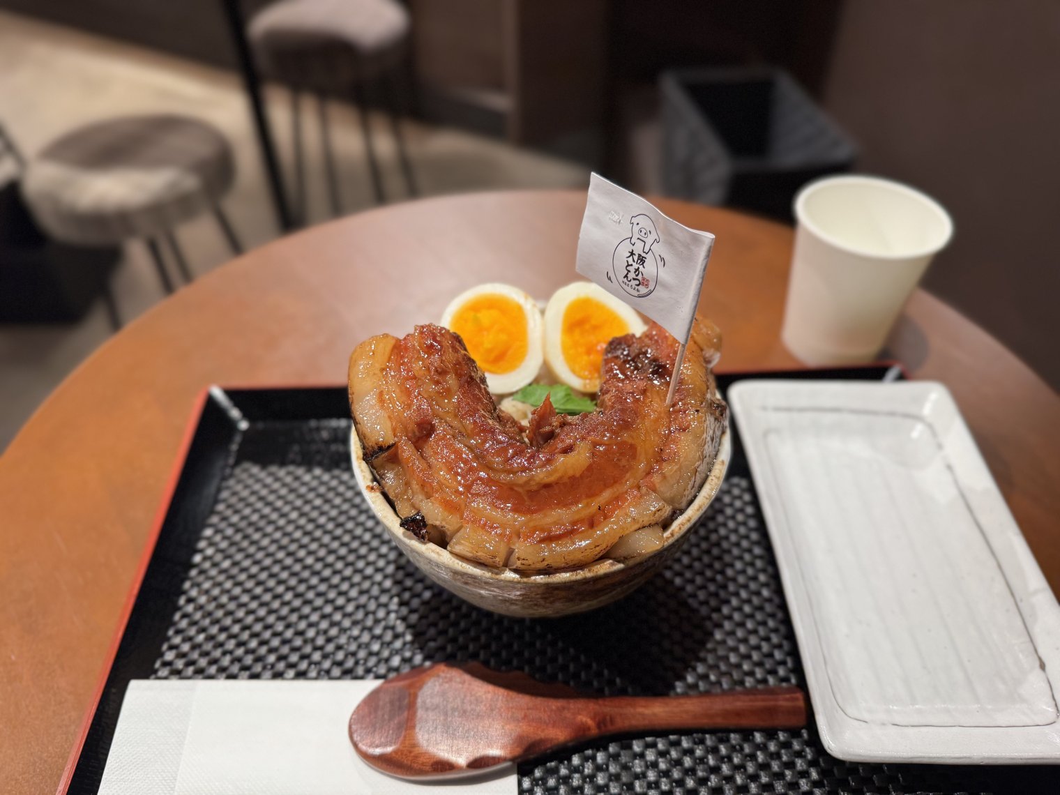A beef bowl except with a humongous slab of pork belly and two half-eggs resembling a smiley face