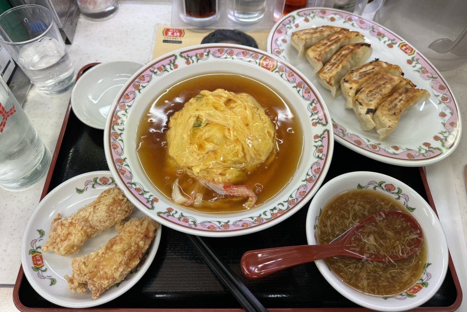 A massive meal with crab & egg main, gyoza, karāge, and bonito soup. 
