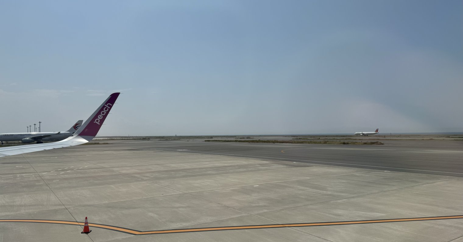 View from window seat on airplane docked at Terminal 2 of Kansai International Airport