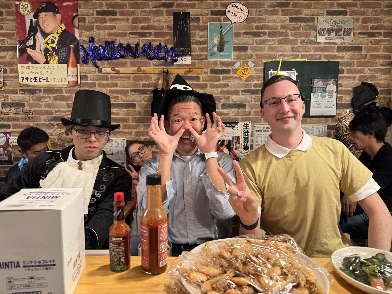 Garion dressed as Nobita from Doraemon, next to two lovely (and equally costumed) regular customers at Bonchi.