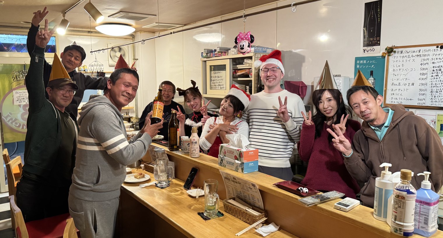 Garion posing in a Santa hat with all the regulars at Bonchi