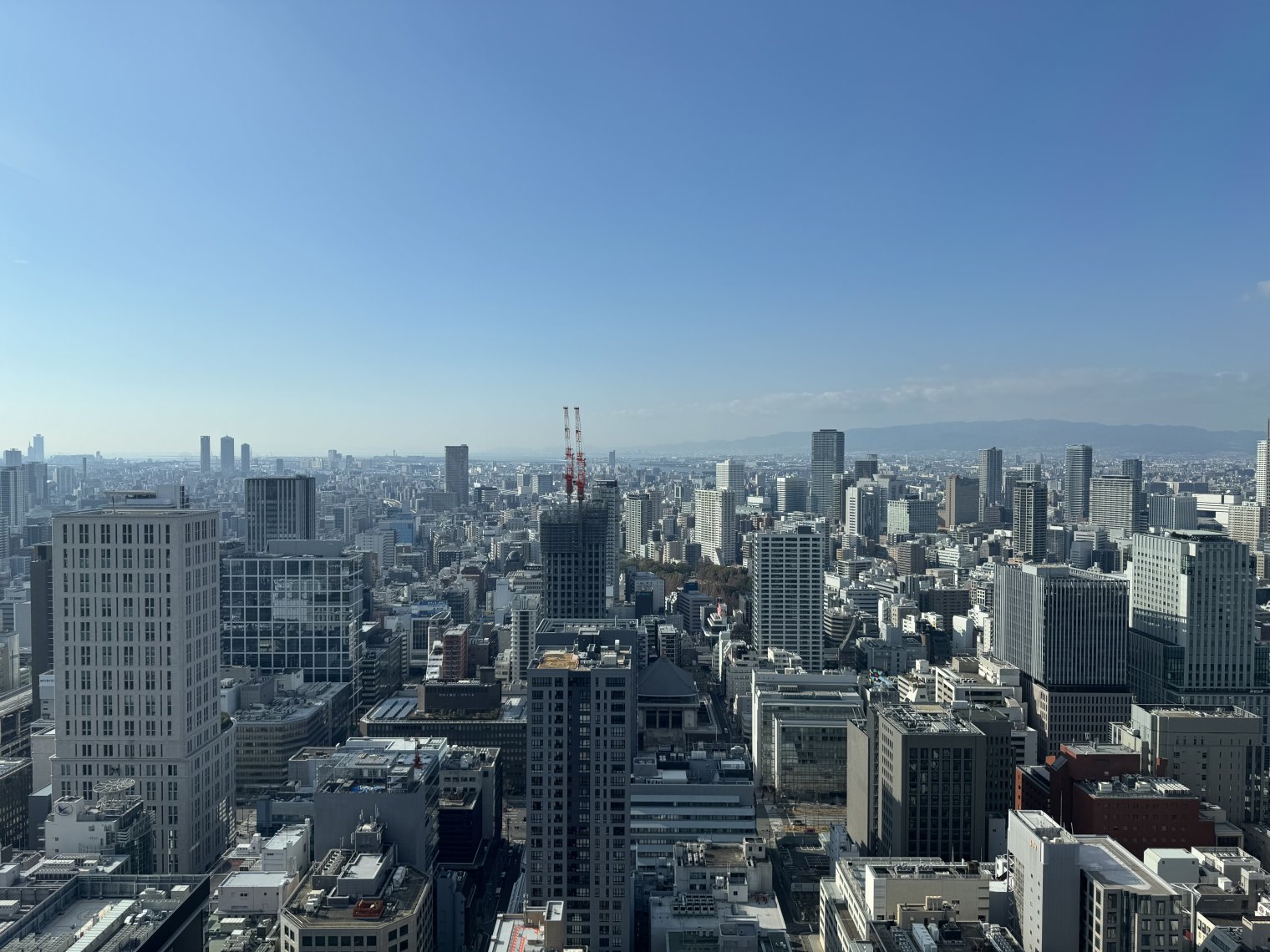 View from the 46th floor overlooking Hommachi, facing west. Kobe is visible, though misty. 