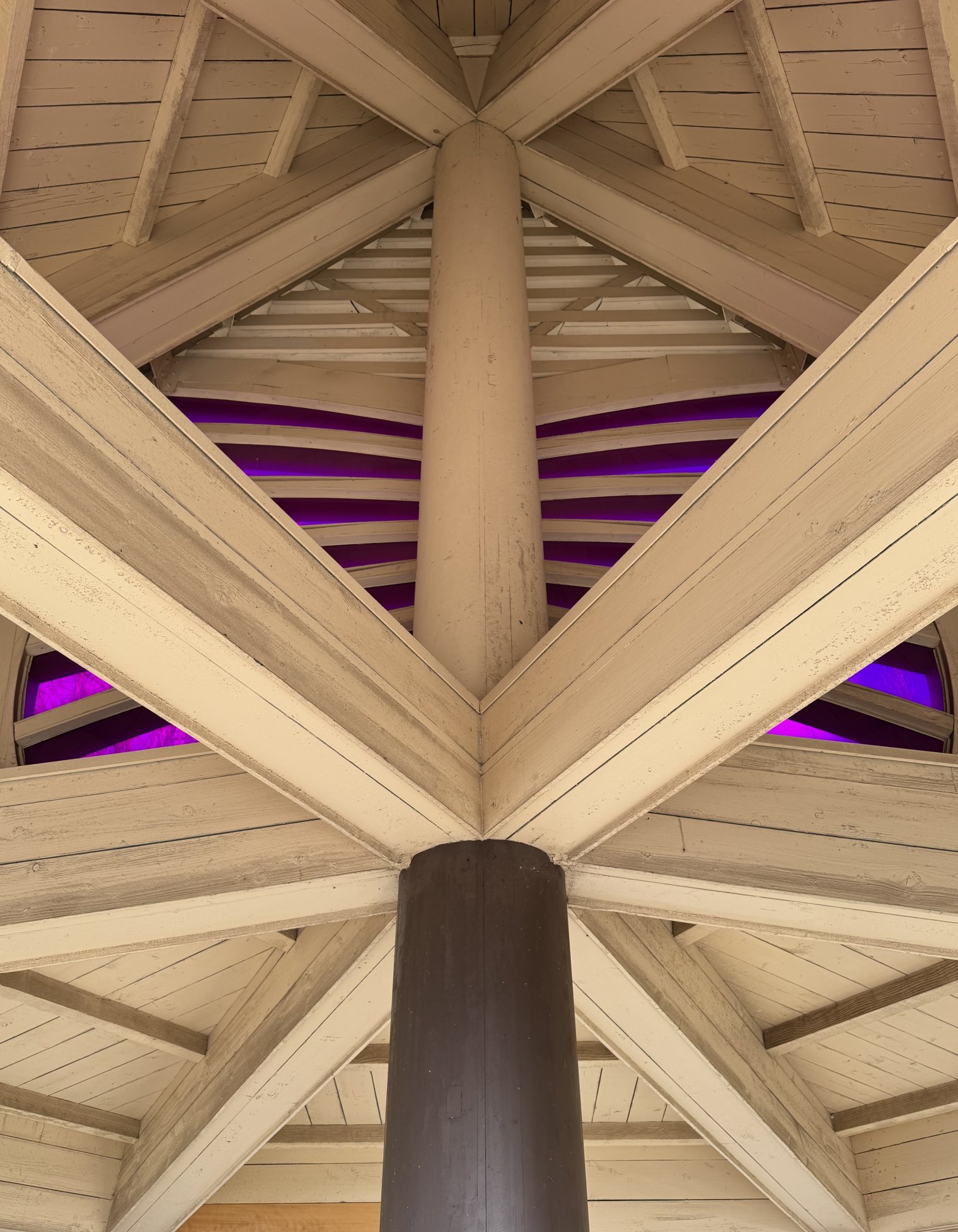 The inside view of the roof of a rest area on a hiking trail in Osaka, Japan. The layout of the panels and supports photographed from a neutral angle create an interesting visual symmetry. 